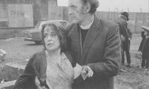 The Rev. Spriggs consoles a survivor after the jumble sale massacre in Castleford