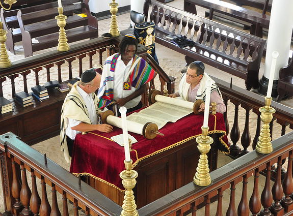 Suriname Jews examining a Torah scroll in the Neve Shalom Synagogue