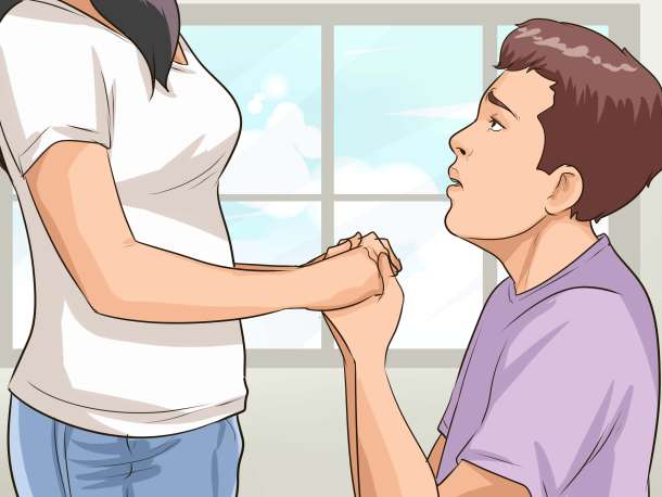 A young man grovelling to his girlfriend