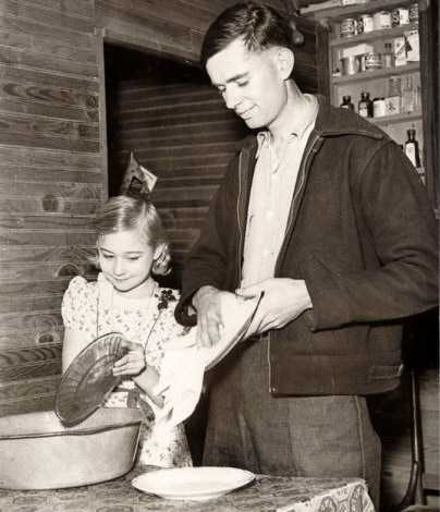 Charlie Johns, 22 and his wife Eunice, 9, doing dishes.